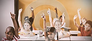 Students raising hands in classroom