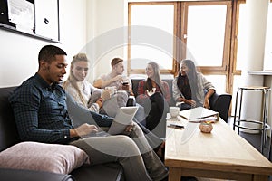 Students Relaxing In Lounge Of Shared Accommodation