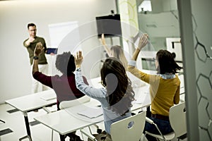 Students rising hands to answer the question during the workshop training