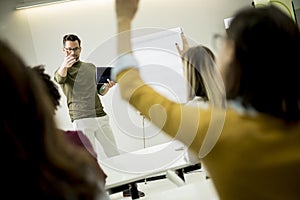 Students rising hands to answer the question during the workshop training