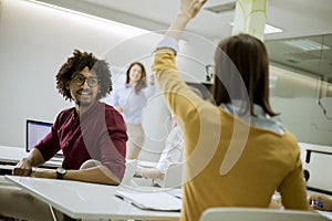 Students rising hands to answer the question during the workshop training