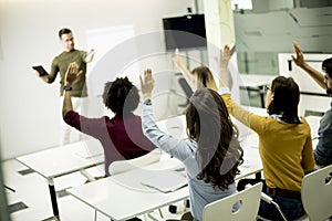 Students rising hands to answer the question during the workshop training