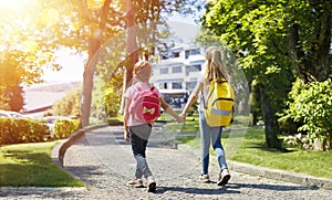 Students With Rucksacks Walking In The Park