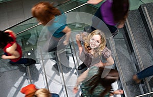 Students rushing up and down a busy stairway -