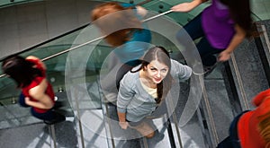 Students rushing up and down a busy stairway -