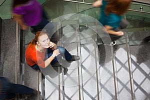 Students rushing up and down a busy stairway