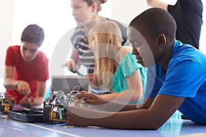 Students In After School Computer Coding Class Building And Learning To Program Robot Vehicle