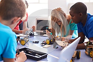 Students In After School Computer Coding Class Building And Learning To Program Robot Vehicle
