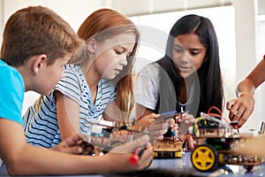 Students In After School Computer Coding Class Building And Learning To Program Robot Vehicle