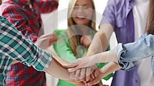 Students in school showing unity with their hands