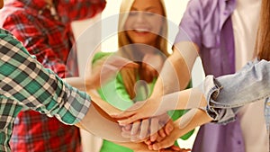 Students in school showing unity with their hands together