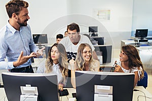 Students sitting in a classroom, using computers during class