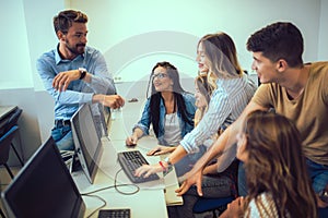 Students sitting in a classroom, using computers during class