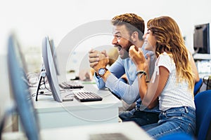 Students sitting in a classroom, using computers during class