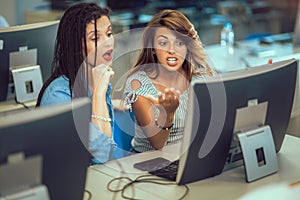 Students sitting in a classroom, using computers during class