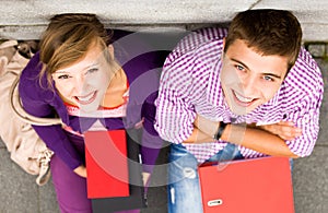 Students sitting by the wall