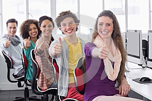 Students smiling at camera in computer class