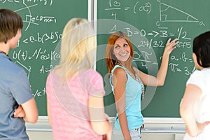 Students standing front of green chalkboard math