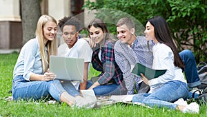 Students studying in group project outdoors in college campus
