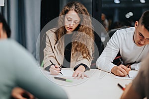 Students studying together in a classroom setting focused on their tasks