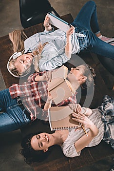Students studying together and lying on table