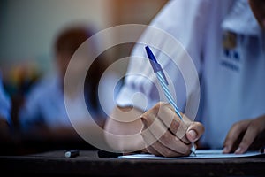 Students taking exam with stress in school classroom