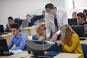 Students with teacher in computer lab classrom photo