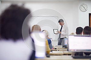 Students with teacher in computer lab classrom photo