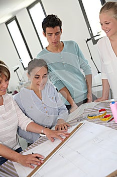 Students with teacher in dressmaking class