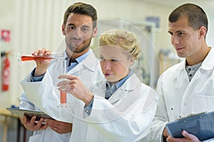 students and teacher experimenting in lab
