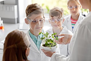 Students and teacher with plant at biology class
