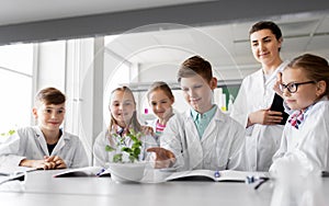 Students and teacher with plant at biology class