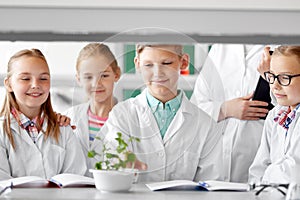 Students and teacher with plant at biology class