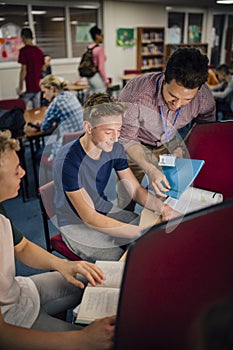 Students and Teacher Working On Computers