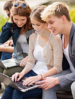 Students or teenagers with laptop computers