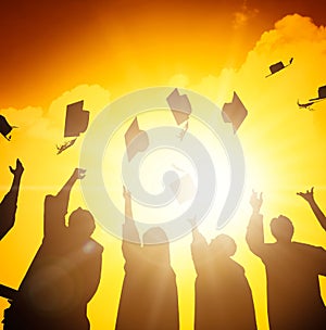 students throwing graduation caps in the Air
