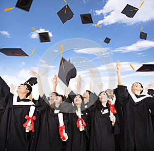 students throwing graduation caps into the Air