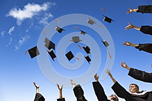 Students throwing graduation hats