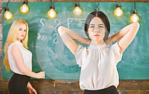 Students and trainees concept. Attractive women preparing for lesson. Girl looks attractive while lady writing on