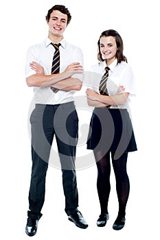 Students in uniform posing with arms crossed