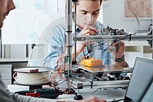 Students using a 3D printer