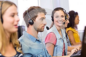 Students using headsets in computer class
