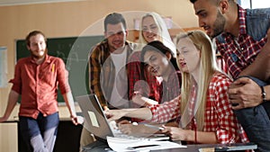 Students using laptop tablet computer people group smile