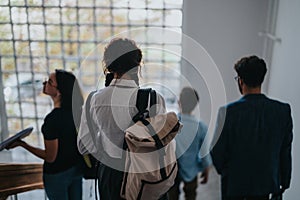 Students walking through campus corridor with professor
