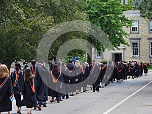 Students walking outdoors to graduation ceremony