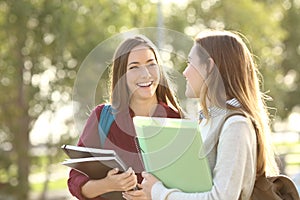 Students walking and talking in a campus photo