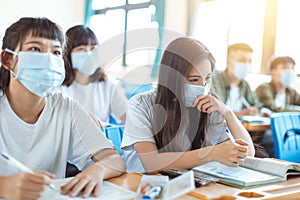 Students wearing  protection mask to prevent germ, virus and PM 2.5 micron in classroom photo