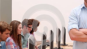 Students working in computer room with lecturer