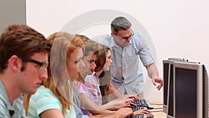 Students working in computer room with lecturer