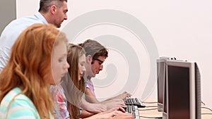 Students working in computer room with lecturer